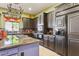 Spacious kitchen with dark cabinetry, granite countertops, and modern appliances at 6428 W Eugie Ave, Glendale, AZ 85304