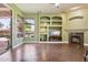 Bright living room featuring a fireplace, built-in shelving, and access to the outdoor pool area at 6428 W Eugie Ave, Glendale, AZ 85304