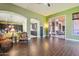 Open-concept living room with wood-look tile flooring, arched doorways, and seamless indoor/outdoor flow at 6428 W Eugie Ave, Glendale, AZ 85304