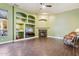 Cozy living room with a fireplace, built-in shelving, and a large window for natural light at 6428 W Eugie Ave, Glendale, AZ 85304