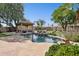 Inviting backyard pool area featuring rock waterfall, mature landscaping, and a covered gazebo at 6428 W Eugie Ave, Glendale, AZ 85304