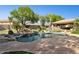 Lush backyard featuring a gorgeous pool with a rock waterfall and a covered gazebo at 6428 W Eugie Ave, Glendale, AZ 85304