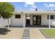 Cozy backyard with stone walkways, lush grass, and a covered patio, great for outdoor entertaining and relaxation at 6723 E 1St Ave, Scottsdale, AZ 85251