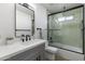 Modern bathroom featuring a shower with glass door, sleek vanity with black fixtures, and a neutral color scheme at 6723 E 1St Ave, Scottsdale, AZ 85251