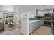 Open-concept living space with a modern kitchen, breakfast bar, and adjacent living room, perfect for entertaining and daily living at 6723 E 1St Ave, Scottsdale, AZ 85251