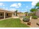 A backyard featuring a pool, desert landscaping and synthetic grass at 719 W Milada Dr, Phoenix, AZ 85041