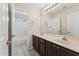 Bathroom featuring double sink vanity, large mirror and shower-tub combo at 719 W Milada Dr, Phoenix, AZ 85041