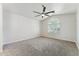 Spacious bedroom with carpeted floors, ceiling fan, and arched window with shutters at 719 W Milada Dr, Phoenix, AZ 85041