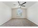 Bright bedroom with carpeted floors, ceiling fan and a beautiful window with white shutters at 719 W Milada Dr, Phoenix, AZ 85041