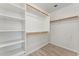 Walk-in closet featuring shelving on the left and multiple wooden racks for clothing storage at 719 W Milada Dr, Phoenix, AZ 85041