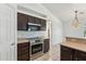 Charming kitchen with stainless steel oven, microwave, tile floors and dark wood cabinetry at 719 W Milada Dr, Phoenix, AZ 85041