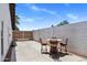 A backyard with a table and chairs. The fenced-in area is concrete at 7510 E Larkspur Dr, Scottsdale, AZ 85260