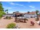 An outdoor backyard, complete with patio seating, a hot tub, a large tiled roof, and a blue sky at 7510 E Larkspur Dr, Scottsdale, AZ 85260