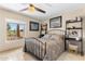 Comfortable bedroom with a view of the neighborhood, a ceiling fan, and built-in shelving at 7510 E Larkspur Dr, Scottsdale, AZ 85260