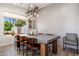 Dining room featuring modern lighting, a large window, and a contemporary table with seating for seven at 7510 E Larkspur Dr, Scottsdale, AZ 85260