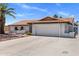 Charming single-story home featuring a tile roof, two-car garage, and low-maintenance desert landscaping at 7510 E Larkspur Dr, Scottsdale, AZ 85260