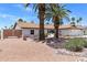 Desert home featuring a tile roof, desert landscaping, and shade trees at 7510 E Larkspur Dr, Scottsdale, AZ 85260