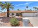 Charming single-story home featuring a tile roof, desert landscaping, and a well-manicured front yard at 7510 E Larkspur Dr, Scottsdale, AZ 85260