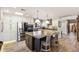 Gourmet kitchen with stainless steel appliances, white cabinets, stone countertops, and an island with seating at 7510 E Larkspur Dr, Scottsdale, AZ 85260