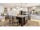 Gourmet kitchen with stainless steel appliances, white cabinets, stone countertops, and an island with seating at 7510 E Larkspur Dr, Scottsdale, AZ 85260