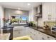 Bright kitchen featuring white cabinets, granite countertops, stainless steel appliances, and a farmhouse sink at 7510 E Larkspur Dr, Scottsdale, AZ 85260