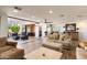 Open-concept living room featuring tile floors, neutral tones, plush seating, and access to the outdoor patio at 7510 E Larkspur Dr, Scottsdale, AZ 85260