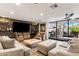 Spacious living room featuring a stone accent wall, modern furniture, and seamless access to the outdoor patio at 7510 E Larkspur Dr, Scottsdale, AZ 85260