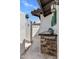 An outdoor kitchen space with stone accents, a sink, and an attached structure for entertaining at 7510 E Larkspur Dr, Scottsdale, AZ 85260