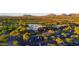 Beautiful aerial view of the property and its golf course, parking lot and surrounding area at 7527 E Nestling Way, Scottsdale, AZ 85255