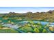 Breathtaking aerial view of the golf course showcasing lush landscapes, water features, and desert mountain views at 7527 E Nestling Way, Scottsdale, AZ 85255