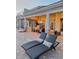 Inviting backyard patio area with lounge chairs, outdoor seating, and elegant lighting near a sparkling pool at 7527 E Nestling Way, Scottsdale, AZ 85255