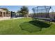 Backyard featuring artificial grass, a pool, and a trampoline at 7527 E Nestling Way, Scottsdale, AZ 85255