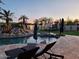 Resort style backyard featuring a pool with a rock waterfall and a basketball court at 7527 E Nestling Way, Scottsdale, AZ 85255