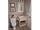 Cozy bathroom with a toilet, sink, and decorative artwork at 7527 E Nestling Way, Scottsdale, AZ 85255