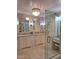 Bright bathroom boasting dual sinks, granite countertops, large mirrors, and seamless glass-enclosed shower at 7527 E Nestling Way, Scottsdale, AZ 85255