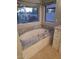 Elegant bathroom featuring a jetted tub with granite surround and backyard view at 7527 E Nestling Way, Scottsdale, AZ 85255
