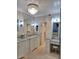 Well-lit bathroom showcasing dual sinks, granite countertops, a stylish chandelier, and convenient vanity seating at 7527 E Nestling Way, Scottsdale, AZ 85255