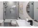 Modern bathroom with sleek vanity, stylish mirror and walk-in shower with updated tile at 7527 E Nestling Way, Scottsdale, AZ 85255