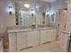 Expansive bathroom featuring dual sinks with granite countertops, large mirrors, and ample vanity storage at 7527 E Nestling Way, Scottsdale, AZ 85255