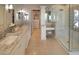 Bright bathroom featuring dual sinks, walk-in shower, vanity area, and neutral colors at 7527 E Nestling Way, Scottsdale, AZ 85255