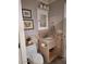 Bathroom features a toilet, sink, decorative artwork, and fixtures at 7527 E Nestling Way, Scottsdale, AZ 85255