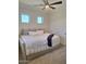 Cozy bedroom with daybed, two small windows and bright neutral decor at 7527 E Nestling Way, Scottsdale, AZ 85255