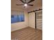 Bright bedroom with ceiling fan, wood floors, and sliding closet door at 7527 E Nestling Way, Scottsdale, AZ 85255
