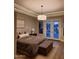 Inviting bedroom with plush bedding, ambient lighting, and seamless access to the outdoors at 7527 E Nestling Way, Scottsdale, AZ 85255