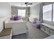 Bright bedroom features a ceiling fan, neutral walls, large window, and white trim at 7527 E Nestling Way, Scottsdale, AZ 85255