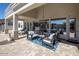 Outdoor living space with comfortable seating, a stone patio, and picturesque views at 7527 E Nestling Way, Scottsdale, AZ 85255