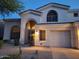 Charming stucco home features an arched entryway and a single-car garage at 7527 E Nestling Way, Scottsdale, AZ 85255