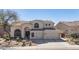 Charming two-story home with a three-car garage and a well-maintained desert landscape at 7527 E Nestling Way, Scottsdale, AZ 85255