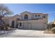 Inviting two-story home boasts a desert landscape and a spacious three-car garage at 7527 E Nestling Way, Scottsdale, AZ 85255