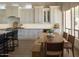 Stylish kitchen with wooden table seating, white cabinets, and modern appliances at 7527 E Nestling Way, Scottsdale, AZ 85255